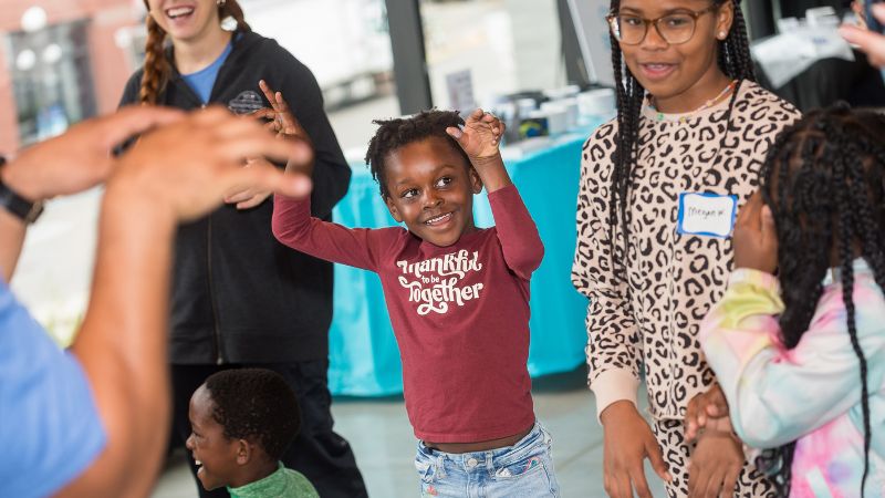 Children laughing and dancing.