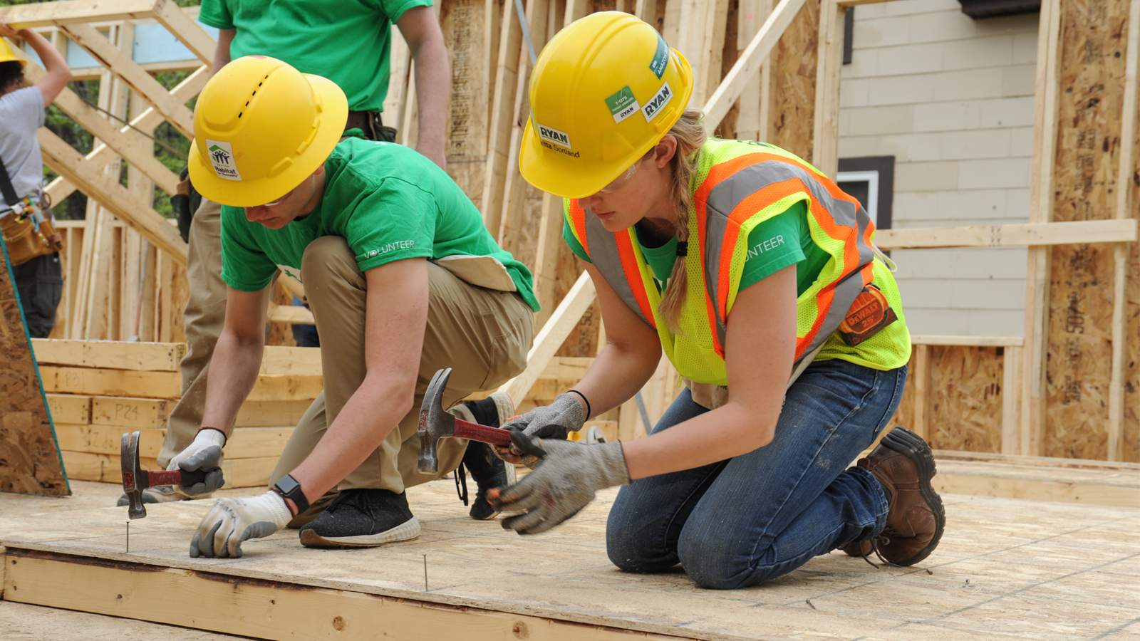 Volunteers hammering nails