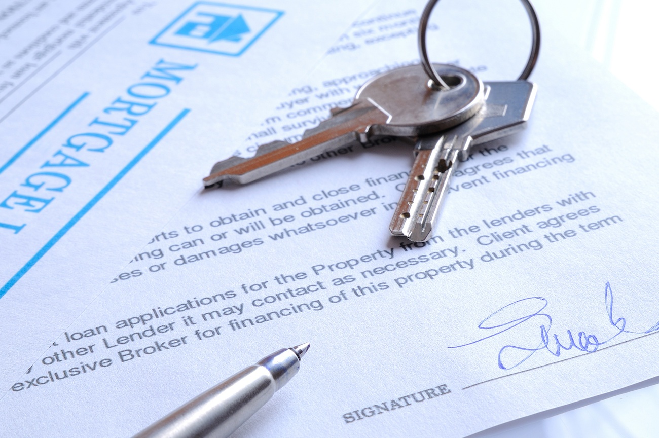 Image of house keys sitting on paperwork.
