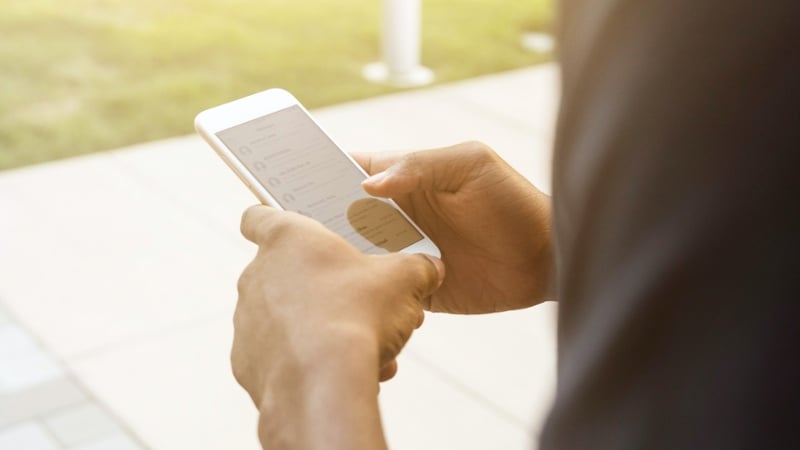 A close-up of a person using their smartphone.