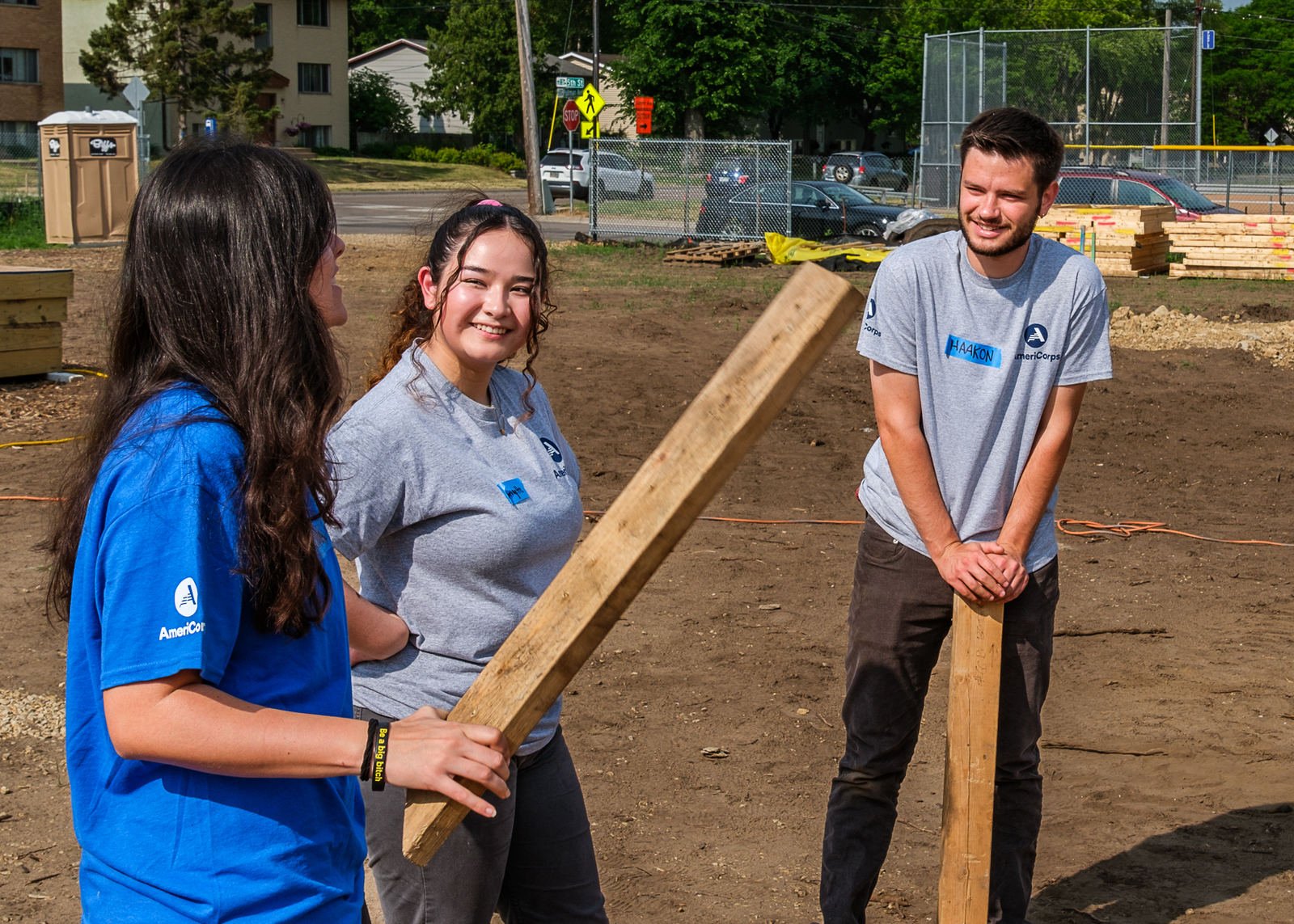 Three summer AmeriCorps members talking during a training